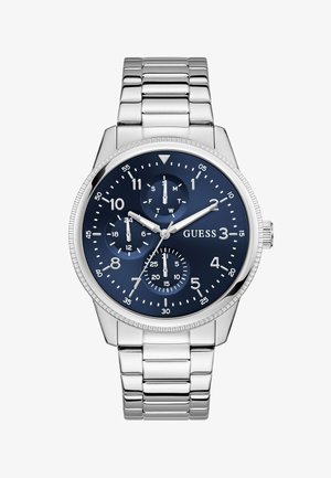 Silver metal bracelet watch with blue dial, three subdials showing 24-hour, day, and seconds, and silver hour and minute hands.
