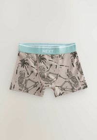 Boxer in cotone con una base beige chiara, caratterizzati da un design di scheletro nero che fa skate e palme, rifiniti con un elastico verde menta.