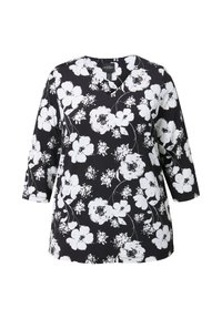 Blumen-Tunika mit schwarzem Hintergrund, verziert mit weißen Blumen und grünen Akzenten, V-Ausschnitt und Dreiviertelärmeln. Sanfte Stofftextur.