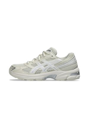 Chaussure de running en mesh gris clair et blanc avec lacets, semelle amortie et bande portant le logo de la marque sur le côté, vue de profil extérieur.