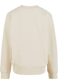 Crème pullover sweatshirt met een geribbelde ronde hals en omgeslagen lange mouwen. Gemaakt van zachte stof, met een minimalistisch ontwerp en zonder patronen.