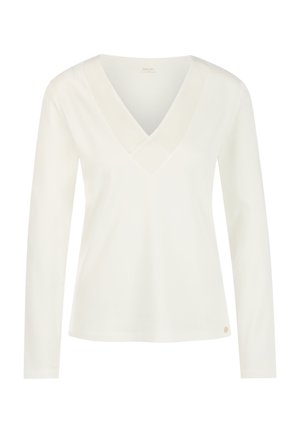 White long-sleeve top with a deep V-neck and a smooth texture. Features a subtle logo accent on the lower left side.