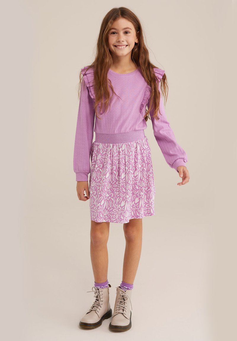 Light purple dress with ruffled sleeves and floral print skirt. Cotton blend fabric; paired with beige boots and purple socks.