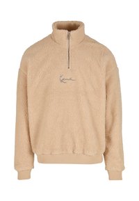 Pulover din fleece bej, cu guler cu fermoar pe jumătate, mâneci și tiv cu model în relief, având logo brodat pe față. Suprafață moale, texturată.