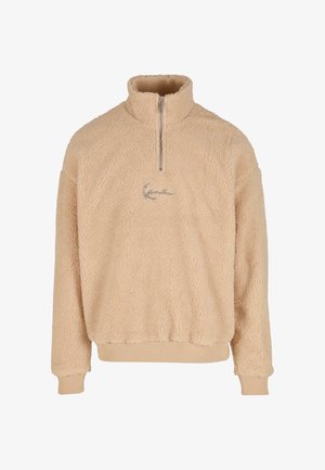 Beige Fleece-Pullover mit halbem Reißverschlusskragen, gerippten Bündchen und Saum sowie gesticktem Logo auf der Vorderseite. Weiche, strukturierte Oberfläche.
