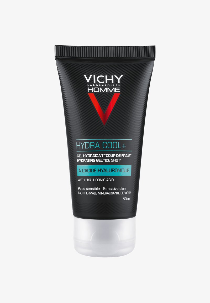 Black tube with a matte finish, featuring a bright red "V" logo. Text in white and turquoise details. Screw-on cap at the bottom. 50 ml size.