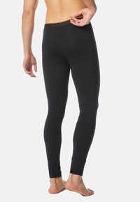 Schwarze Leggings aus glattem Stoff, mit enger Passform, einem orangen Bund und seitlichen Öffnungen an den Knöcheln für Atmungsaktivität.