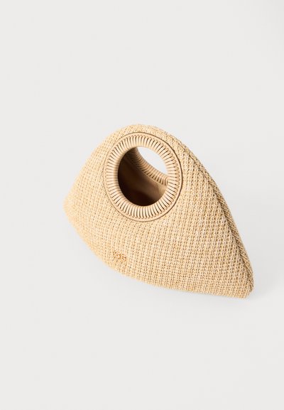 Textured triangular handbag in beige woven material, featuring a circular cutout handle and subtle branding at the base.