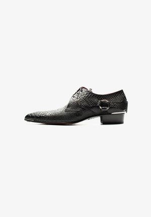 Black leather dress shoe with a textured surface and pointed toe. Features lace closure and a small metallic accent on the side.