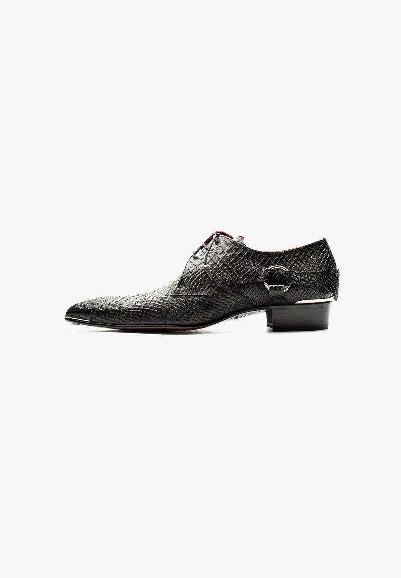 Black leather dress shoe with a textured surface and pointed toe. Features lace closure and a small metallic accent on the side.