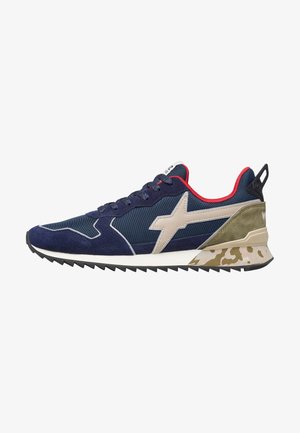 Navy athletic shoe with a mix of suede and mesh, featuring a beige star logo, red accents, and a camo-patterned sole.