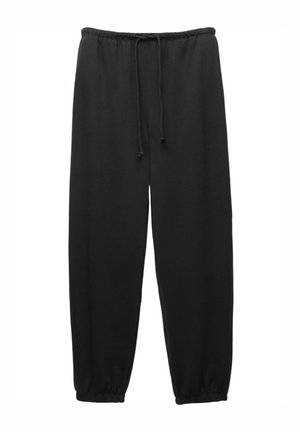 Pantalons de survêtement noirs en tissu doux, dotés d'une taille élastique avec cordon de serrage et de chevilles resserrées.