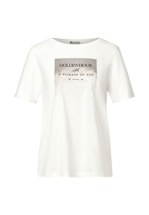 T-shirt en coton blanc à manches courtes et col rond. Présente un design graphique métallique avec l'inscription "HOUR D'OR" et une texture chatoyante.