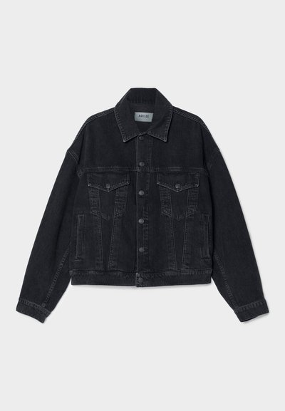 Black denim jacket featuring a classic design, pointed collar, two chest pockets, button closure, and slightly oversized fit with finished hems.