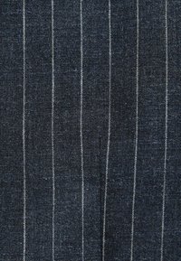 Dark blue fabric with thin, light-colored vertical stripes. Textured weave, smooth finish, and a tailored appearance. No visible patterns or accents.