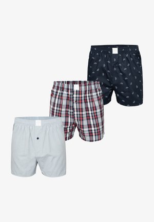 Three pairs of men's boxers: gray solid, red and blue plaid, and navy with small white patterns. All feature elastic waistbands and button closures.