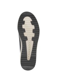 Semelle noire en caoutchouc avec des rainures pour une traction, présentant un intercalaire de couleur claire et un motif de bande de roulement distinctif.