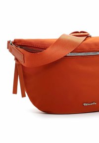 Orange nylon crossbody bag with a smooth texture, zip closure, and an adjustable strap. Features a metallic logo tag and minimalist design.
