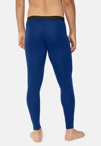 Leggings blu con un elastico in vita nero, caratterizzati da una texture liscia e un design aderente. Nessun motivo o logo visibile.