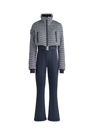 Mornarska smučarska obleka z izrezanim, teksturiranim jopičem z visokim ovratnikom in sprednjim zadrgo, v kombinaciji s širokimi hlačami in pasom.