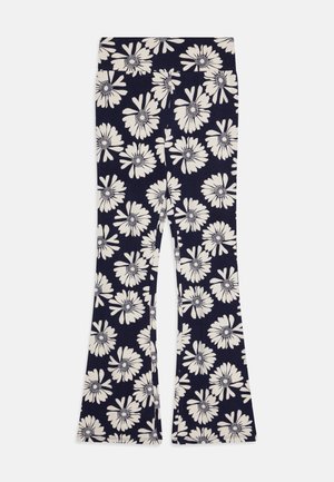 Leggings évasés bleu marine avec un motif de marguerites blanches, dotés d'une taille ajustée et d'un tissu doux et extensible pour le confort et la liberté de mouvement.