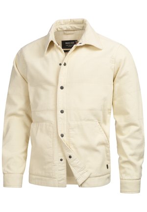 Cream corduroy jacket with a collared neckline, front snap closures, two large patch pockets, and ribbed cuffs. Features a textured fabric.