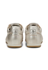 Metallic gold shoes with a smooth texture, featuring a round heel and contrasting tan sole, displaying logo detail on the back.