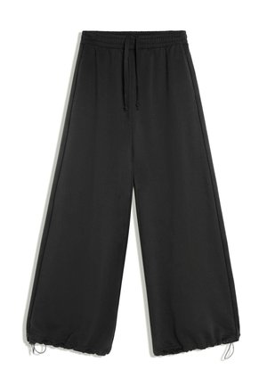 Pantalon noir à jambes larges avec taille élastique et cordon, avec poignets élastiques ajustables aux chevilles.