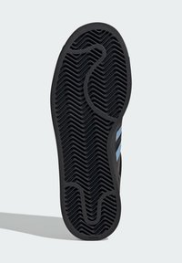 Black rubber shoe sole with a textured herringbone pattern and rounded edges, featuring blue accent stripes along the sides.