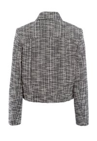 Cropped jacket in a black and white textured fabric, featuring a collar and long sleeves, with a checkered pattern throughout.