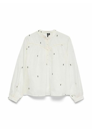 Blouse blanche à manches longues avec petits clusters de points noirs, boutonnage sur le devant, empiècement froncé et encolure ronde.