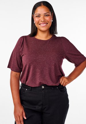 Burgundy short-sleeve top with a round neckline and subtle texture, paired with black high-waisted pants. Features puffed sleeves.