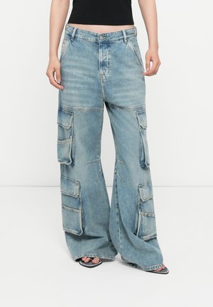 Light blue cargo pants with a relaxed fit, multiple side pockets, and a faded denim texture. Features a button and zipper closure.