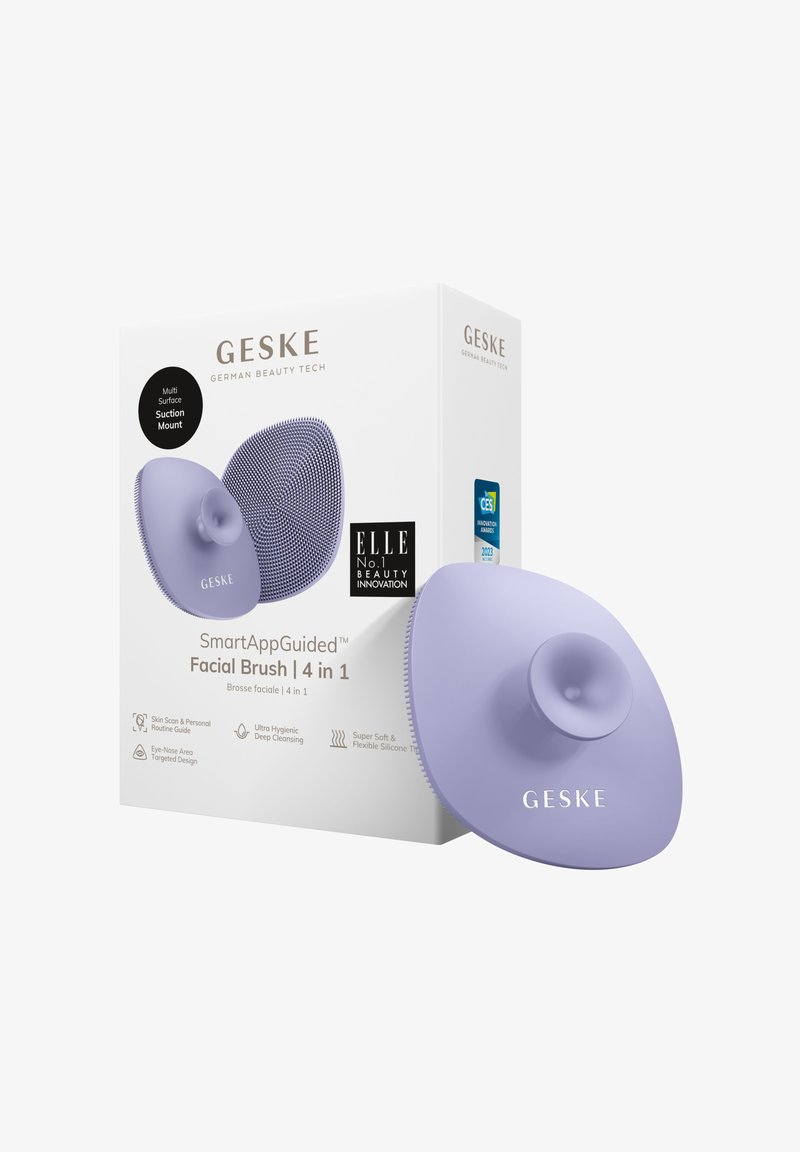 Lila Silikon-Gesichtsborste mit einem Design mit Saugnapf, ausgestattet mit strukturierten Borsten und einem runden Griff, verpackt in einer eleganten Schachtel.