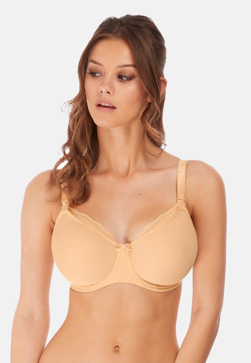 Beige padded bra with lace accents, smooth texture, and adjustable straps. Features a bow detail at the center and seamless design.