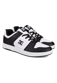 Black and white sneakers with a leather upper, featuring a textured finish, lace-up design, and logo on the side. Classic low-top shape.