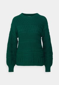 Pull vert foncé en tricot avec des motifs texturés, y compris des torsades et des côtes. Il présente un col rond et des manches longues.