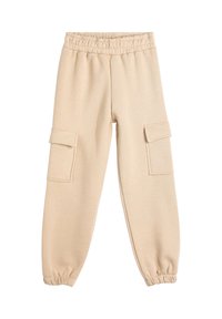Beige sweatpants med elastisk talje, tætsiddende ærmer og to sidelommer. Lavet af blødt stof med en glat tekstur.