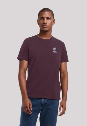 Maroon cotton t-shirt with a round neckline and short sleeves. Features a small smiling graphic and text on the left chest area.