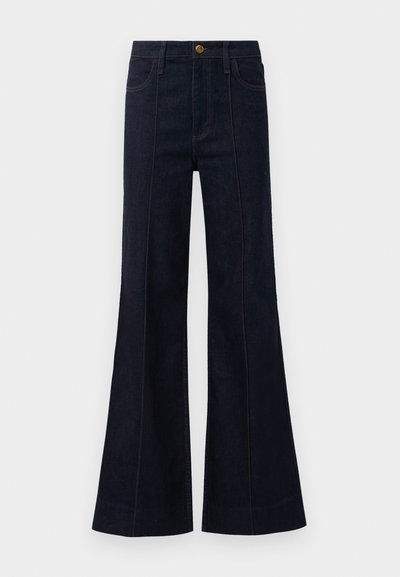 Dark blue denim flared jeans with a high waist, front pockets, and visible stitching. The fabric has a smooth texture and structured shape.