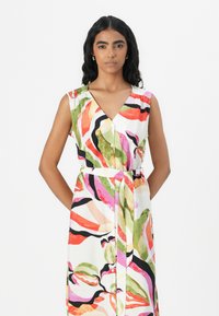 Floral-patterned dress in lightweight fabric, featuring a V-neck, sleeveless design, button-front closure, and a tie belt at the waist.