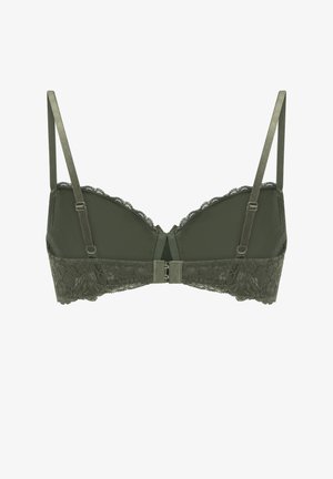 Grüner Spitzenslip aus weichem Material, mit verstellbaren Trägern, gewellten Kanten und einem Hakenverschluss auf der Rückseite.