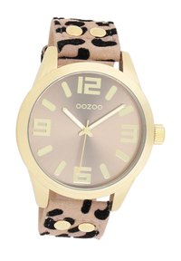 Gold-tone wristwatch with a beige animal print suede strap, a champagne-colored dial, and large, contrasting hour markers.