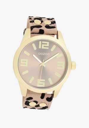 Montre-bracelet dorée avec un bracelet en daim beige à motif animal, un cadran couleur champagne et de grands marqueurs d'heure contrastés.