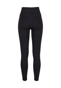 Sorte højtaljede sømløse leggings med ribbet linning og tætsiddende ankellængde vist bagfra på hvid baggrund.