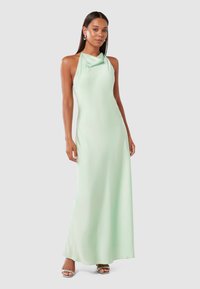 Light green halter maxi dress in smooth fabric with a draped neckline and a fitted silhouette, featuring minimal seams and no visible patterns.