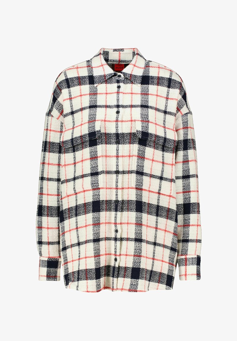 Flanellen shirt met een crèmekleurige basis, marineblauw en rood geruit patroon. Voorzien van knoopsluiting, lange mouwen en twee borstzakken.