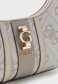 Gray synthetic shoulder bag with quilted pattern, gold hardware logo, and design accents in smooth material; features zipper closure.