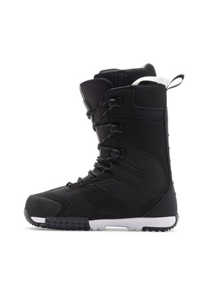 Black snowboarding boot with a textured surface, lacing system, high ankle support, and white sole with grip pattern.
