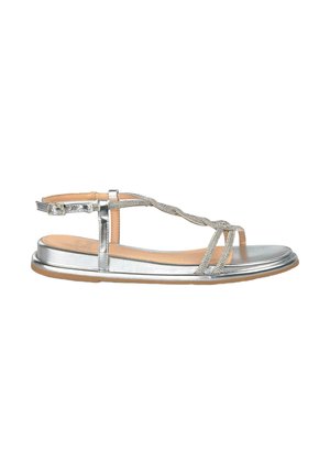 Silver flat sandal with a T-strap design, braided detail, and a rounded toe. Features an adjustable ankle strap and flat sole.